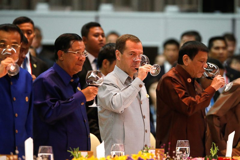 From left Prime Minister Hun Sen Russian Prime Minister Dmitry Medvedev and Philippine President Rodrigo Duterte drink wine during a gala dinner at the close of the Asean Summit in Vientiane on Wednesday night