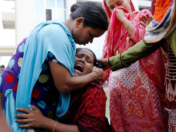 A woman mourns at a hospital after a fire broke out at a packaging factory outside Dhaka Bangladesh