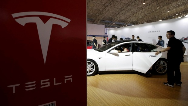 People view a Tesla car during the Auto China 2016 in Beijing China