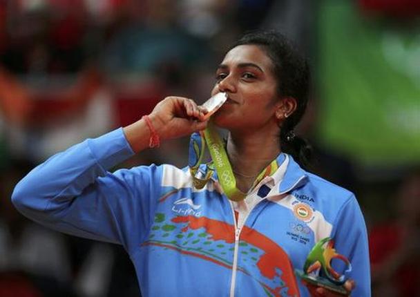 Silver medallist P.V. Sindhu of India poses kissing her medal