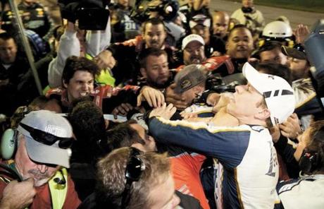 Brad Keselowski right is punched during a fight after the NASCAR Sprint Cup Series auto race at Texas Motor Speedway in Fort Worth Texas Sunday Nov. 2 2014. The crews of Jeff Gordon and Keselowski fought after the race