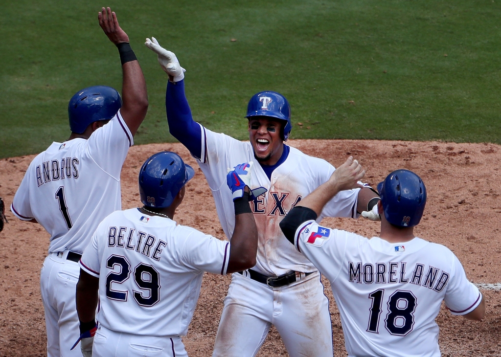 ARLINGTON TX- AUGUST 31 Carlos Gomez #14 of the Texas Rangers celebrates with Elvis Andrus #1 of the Texas Rangers Adrian Beltre #29 of the Texas Rangers and Mitch Moreland #18 of the Texas Rangers after hitting a grand slam against Felix Hernandez