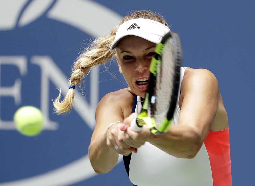 Caroline Wozniacki of Denmark returns a shot to Svetlana Kuznetsova of Russia during the second round of the U.S. Open tennis tournament Wednesday Aug. 31 2016 in New York