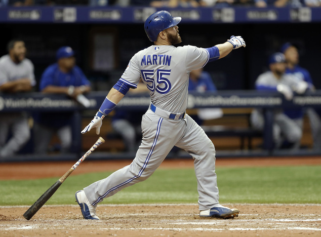 Toronto Blue Jays Russell Martin watches his two-run home run off Tampa Bay Rays relief pitcher Kevin Jepsen during the eighth inning of a baseball game Su