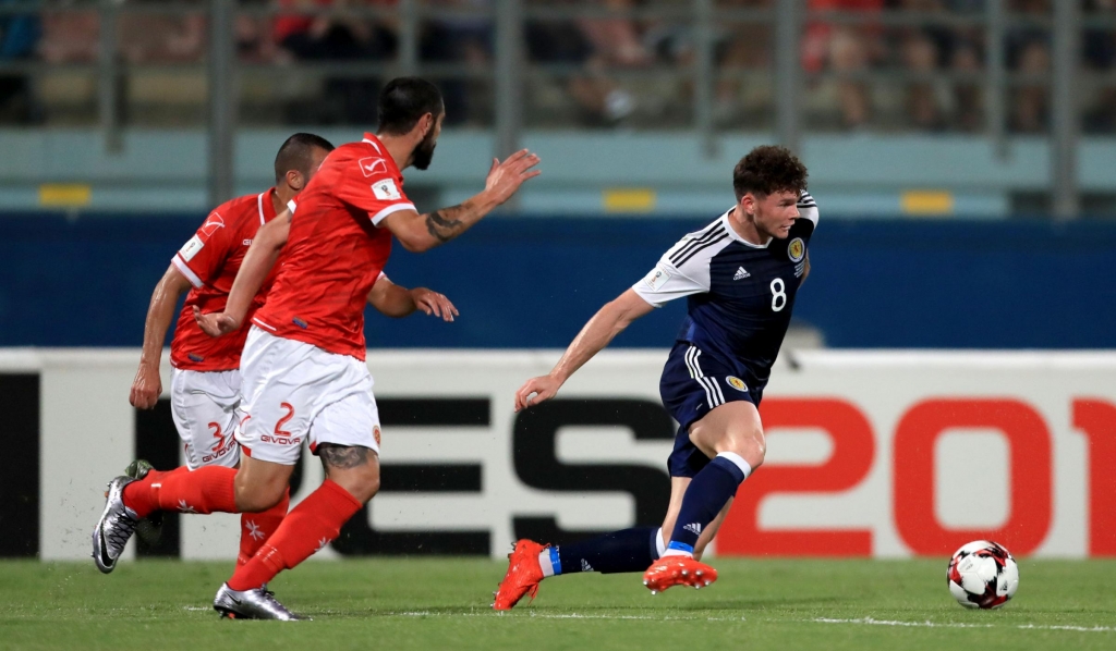 Evening Times Scotland's Oliver Burke and Malta's Jonathan Caruana battle for the ball during the 2018 FIFA World Cup Qualifying match at the Ta'Qali National Stadium Malta. PRESS ASSOCIATION