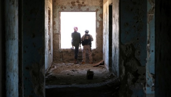 Rebel fighters stand in a damaged building in Quneitra countryside Syria Sept. 10 2016