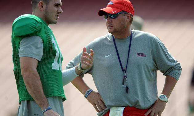 Mississippi quarterback Chad Kelly left talks with head coach Hugh Freeze during NCAA college football practice in Oxford Miss. Freeze made a surprise choice to protect the team’s most valuable asset. Junior