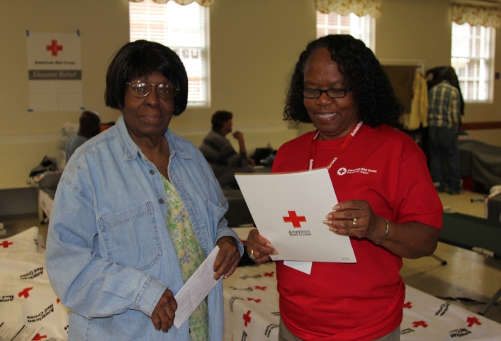 A Red Cross volunteer assists a fellow Lowcountry resident in a North Charleston shelter during the devastating floods of October 2015