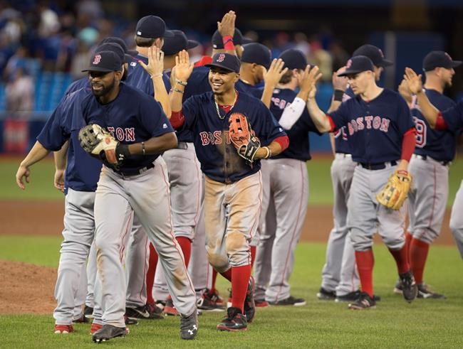 Boston Red Sox centre fielder Jackier Bradley Jr. front left and right fielder Mookie Betts front centre celebrate with teammates after defeating the Toronto Blue Jays in American League MLB baseball action in Toronto on Friday