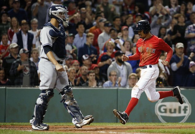 Boston Red Sox's Mookie Betts right scores in front of New York Yankees Gary Sanchez on a single by David Ortiz during the first inning of a baseball game