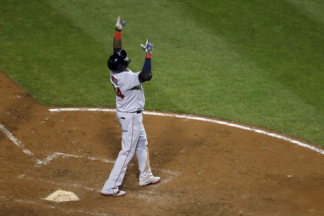 Boston Red Sox's David Ortiz gestures after crossing home plate on a three-run home run in the seventh inning of a baseball game against the Baltimore Oriole