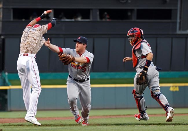 Cincinnati Reds&#39 Billy Hamilton left is out in a rundown between third and home as St. Louis Cardinals&#39 Jedd Gyorko middle and Yadier Molina defend during the first inning of a baseball game Friday Sept. 2 2016 in Cincinnati. (AP