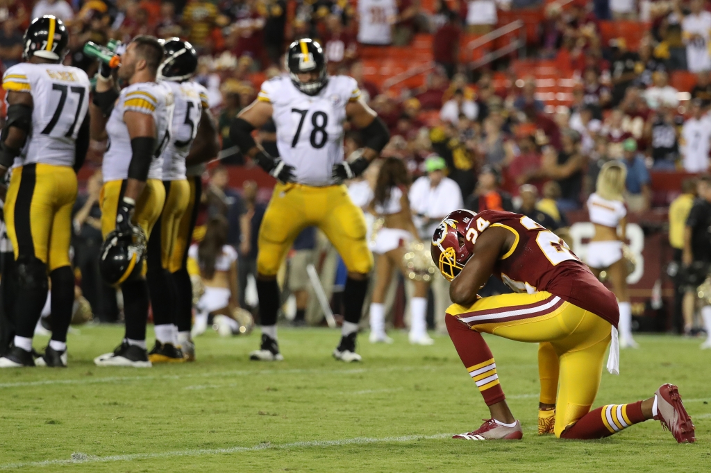 LANDOVER MD- SEPTEMBER 12 Defensive back Josh Norman #24 of the Washington Redskins takes a knee while tackle Alejandro Villanueva #78 of the Pittsburgh Steelers looks on during the fourth quarter at FedExField