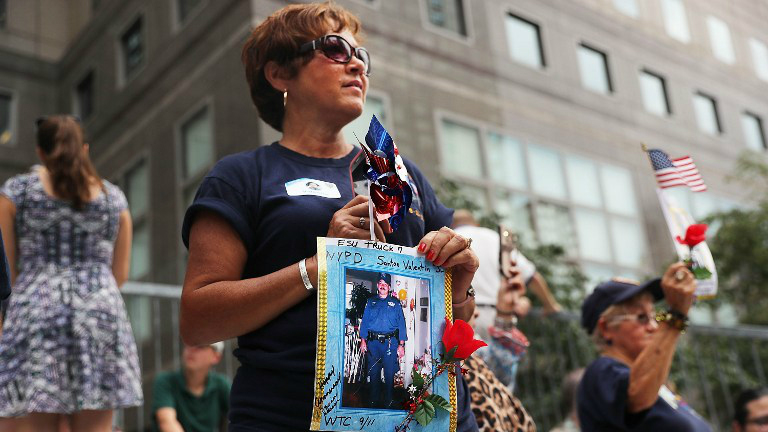 Family members of fallen officers watch a procession in Lower Manhattan to mark the 15th anniversary of the 9/11 attacks and the police officers who were killed during and after the event