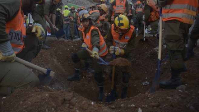 Rescue personnel digging in the search for missing workers at a construction site collapse in Tel Aviv Sept. 5 2016