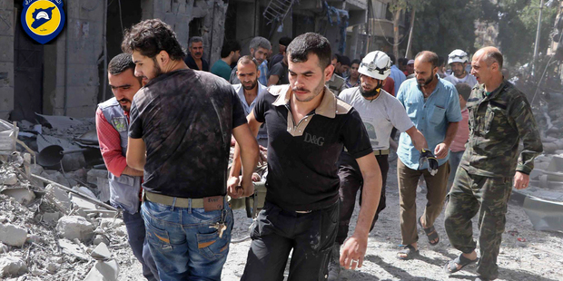 Rescue workers work the site of airstrikes in al Mashhad neighborhood in the rebel-held part of eastern Aleppo Syria