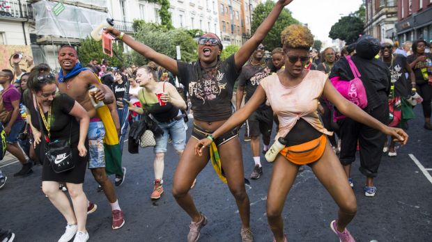 Revellers dance at the Notting Hill Carnival in London England