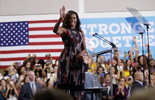 First lady Michelle Obama waves during a campaign rally in support of Democratic presidential candidate Hillary Clinton and vice presidential candidate Sen. Tim Kaine D-Va. Friday Sept. 16 2016 at George Mason University in Fairfax Va. (AP