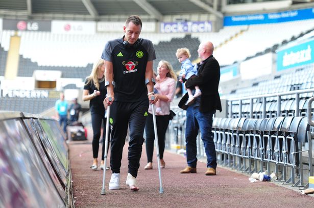 John Terry of Chelsea leaves the liberty stadium on crutches