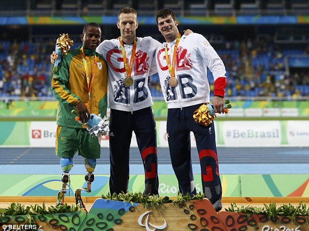 Richard Whitehead poses with David Henson and silver medalist Ntando Mahlangu