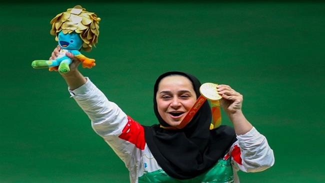 Iran’s physically-challenged female shooter Sareh Javanmardidodmani poses with her gold medal at the end of P2 10m air pistol shooting competitions at the 2016 Summer Paralympics in Rio de Janeiro Brazil