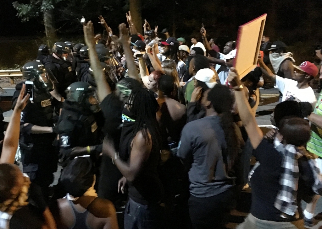 Riots break out after police shoot dead 'disabled black man waiting for his son&#039