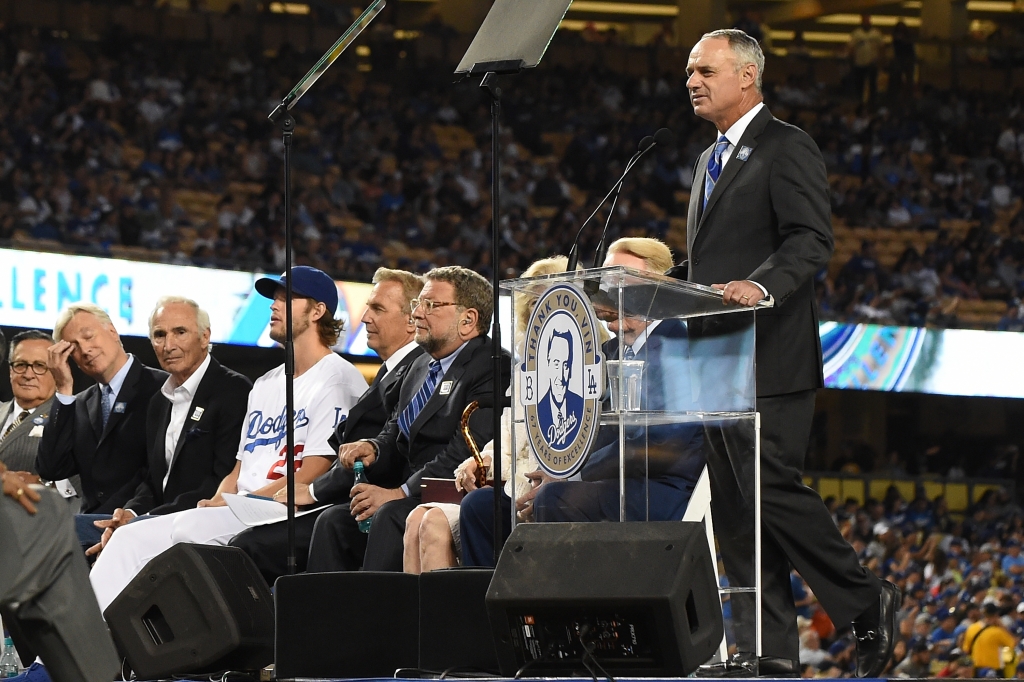 Major League Baseball Commissioner Rob Manfred addresses the crowd during a retirement ceremony for Vin Scully before the game betweens the Colorado Rockies and the Los Angeles Dodgers at Dodger Stadium