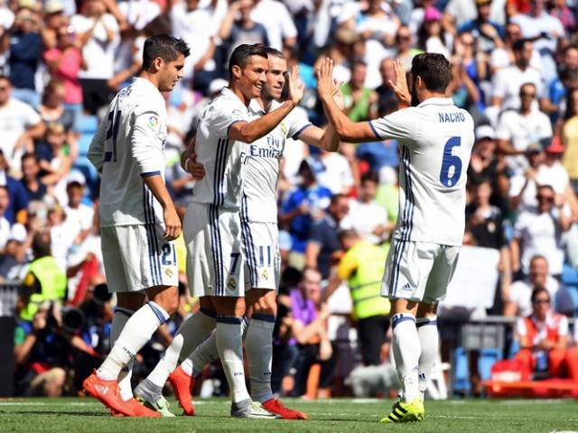 Real Madrid's Portuguese forward Cristiano Ronaldo celebrates with teammates after scoring during the Spanish league football match Real Madrid CF vs CA Osasuna at the Santiago Bernabeu stadium in Madrid