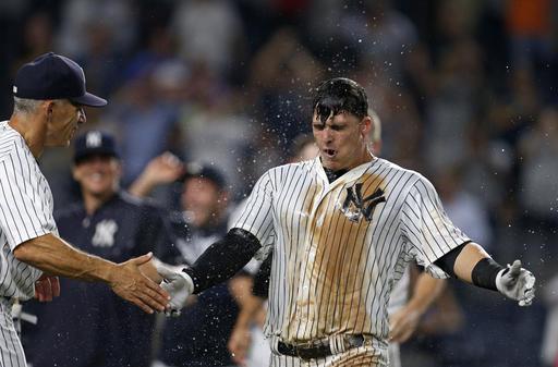 Rookie Tyler Austin is congratulated by Yankees manager Joe Girardi after hitting a walk-off home run on Thursday