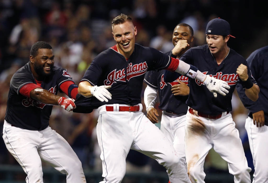 Cleveland Indians&#039 Brandon Guyer second from left celebrates with Abraham Almonte left and Tyler Naquin after hitting a game-winning double off Kansas City Royals relief pitcher Joakim Soria during the ninth inning of a baseball game Tuesday Sep