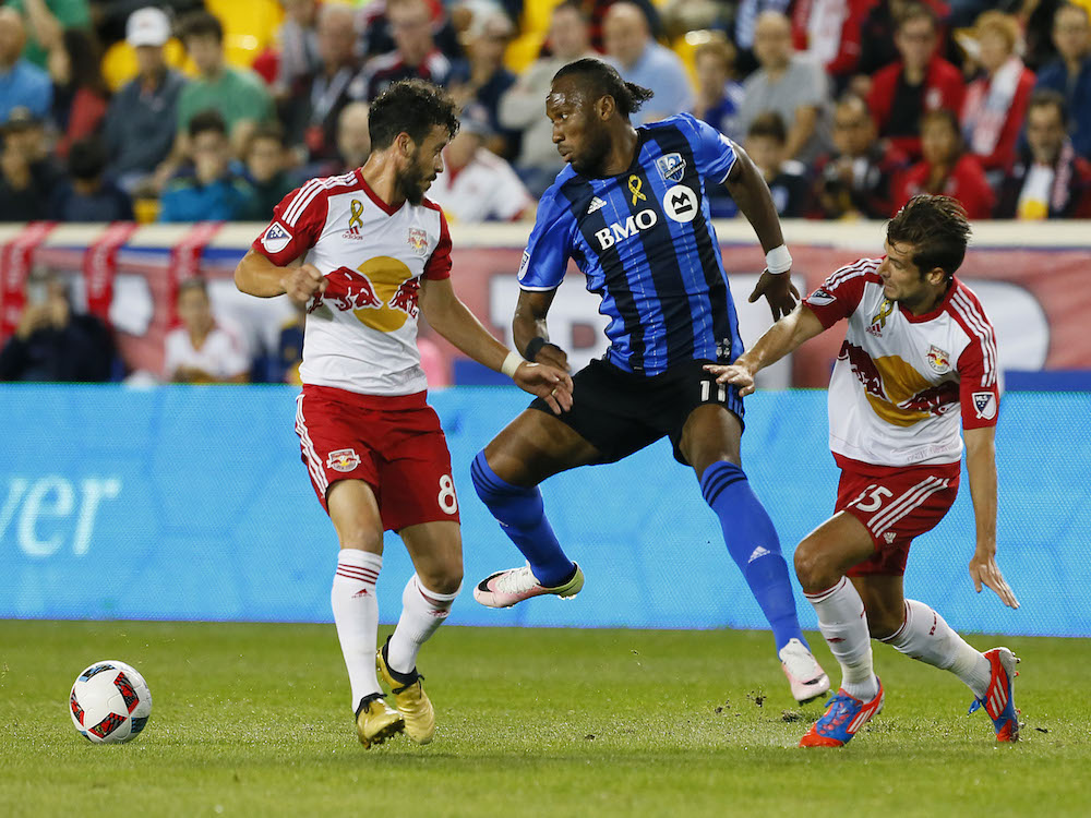 New York Red Bulls midfielder Felipe Martins and Montreal Impact forward Didier Drogba and New York Red Bulls midfielder Salvatore Zizzo battle for the ball during first half at Red Bull Arena on Saturday Sept. 24 2016