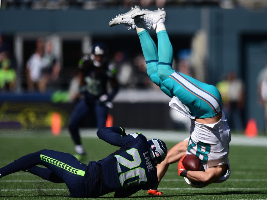 Miami Dolphins tight end Jordan Cameron gets upended by Seattle Seahawks cornerback Jeremy Lane on Sunday Sept. 11 2016 at Century Link Field in Seattle Wash