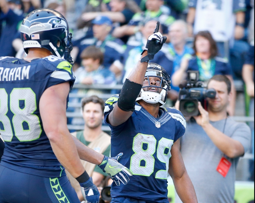 SEATTLE WA- SEPTEMBER 11 Wide receiver Doug Baldwin #89 of the Seattle Seahawks celebrates with teammates after scoring a touchdown against the Miami Dolphins in the fourth quarter at Century Link Field