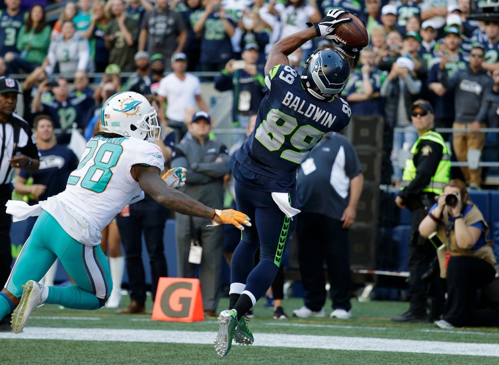 Seattle Seahawks wide receiver Doug Baldwin catches a pass for a touchdown over Miami Dolphins cornerback Bobby Mc Cain in the second half of an NFL football game Sunday Sept. 11 2016 in Seattle