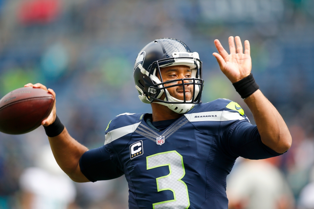 SEATTLE WA- SEPTEMBER 11 Quarterback Russell Wilson #3 of the Seattle Seahawks does warmup passes before an NFL game against the Miami Dolphins at Century Link Field