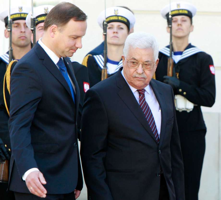 Polish President Andrzej Duda left and Palestinian President Mahmoud Abbas inspect the honor guard during an official welcoming ceremony in the courtyard of the presidential palace in Warsaw Poland Tuesday Sept. 6 2016