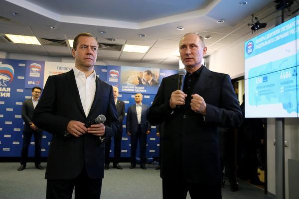 Russian President Vladimir Putin Prime Minister and Chairman of the United Russia party Dmitry Medvedev visit the party's campaign headquarters following a parliamentary election in Moscow Russia on Sunday