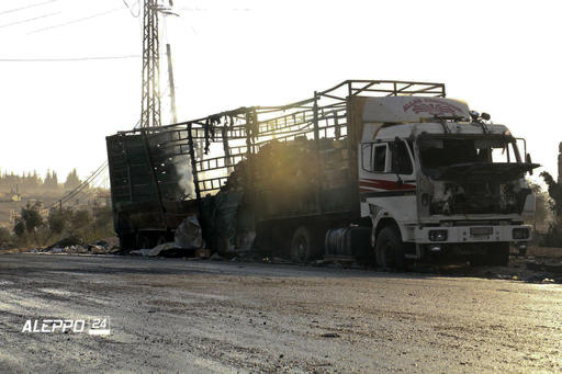 This image provided by the Syrian anti-government group Aleppo 24 news shows a vest of the Syrian Arab Red Crescent hanging on a damaged vehicle in Aleppo Syria Tuesday Sept. 20 2016. A U.N. humanitarian aid convoy in Syria was hit by airstrikes Mon