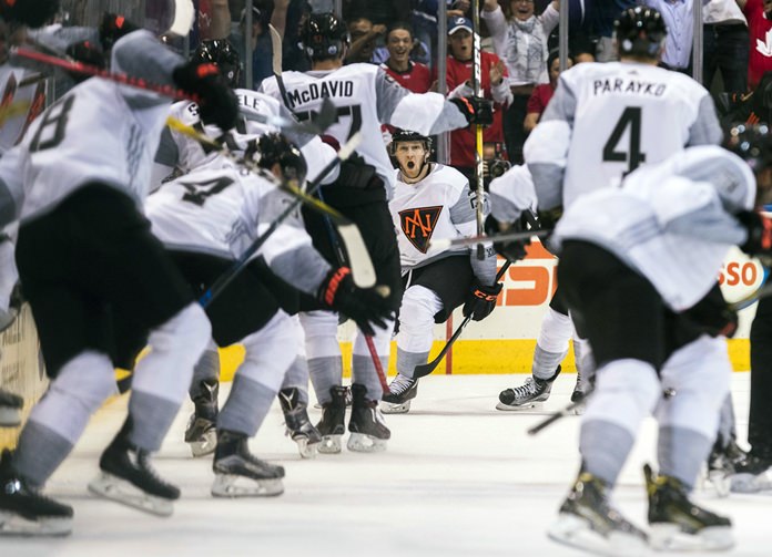 North America's Nathan MacKinnon center celebrates his game-winning goal against Sweden during overtime of a World Cup of Hockey game in Toronto Wednesday Sept. 21