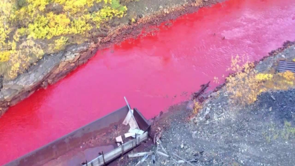 Locals stunned to discover waterway has turned bright RED in Siberia