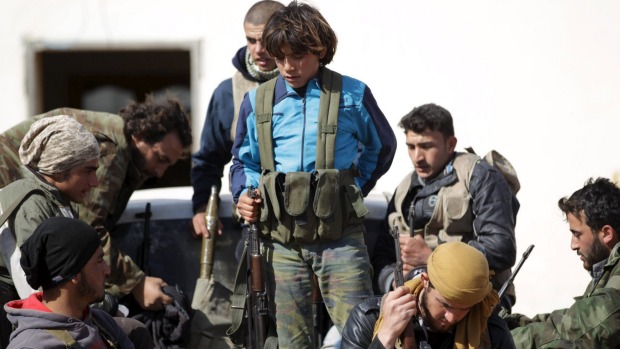 Rebel fighters from'Jaysh al-Sunna gather for a change of guards in Tel Mamo village in the southern countryside