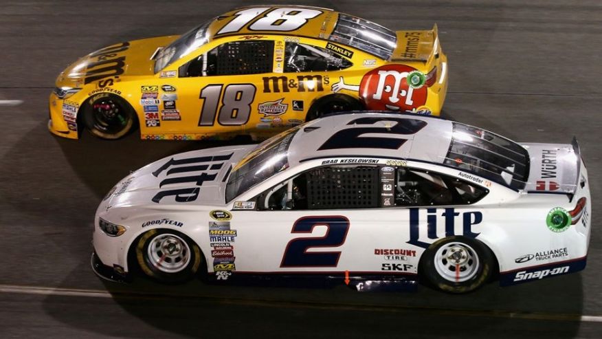 RICHMOND VA- SEPTEMBER 10 Kyle Busch driver of the #18 M&M's 75th Anniversary Toyota races Brad Keselowski driver of the #2 Miller Lite Ford during the NASCAR Sprint Cup Series Federated Auto Parts 400 at Richmond International Raceway on Sept