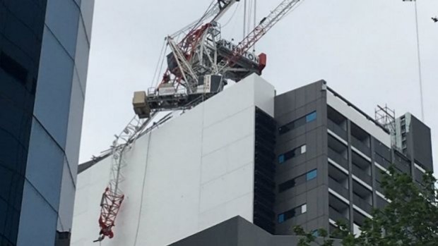 SEBASTIAN BIRD 
 
   Workers dangle from a collapsed crane at a North Sydney building site