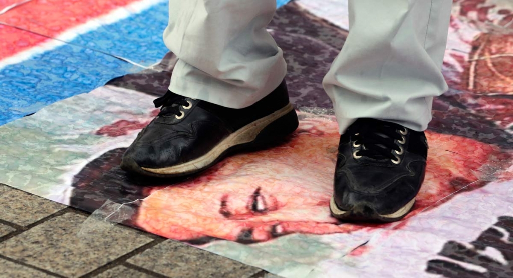 A South Korean protester tramples a caricature of North Korean leader Kim Jong Un during a rally denouncing North Korea's latest nuclear test in Seoul South Korea Monday Sept. 12 2016