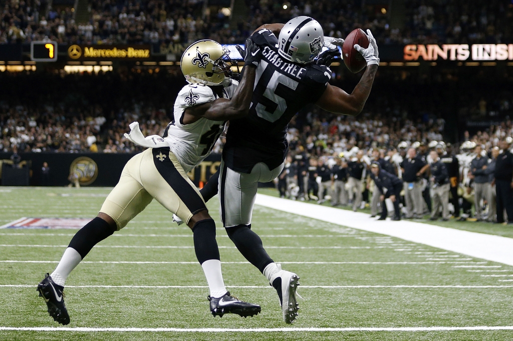 NEW ORLEANS LA- SEPTEMBER 11 Michael Crabtree #15 of the Oakland Raiders catches a pass over Delvin Breaux #40 of the New Orleans Saints completing a two-point conversion to take the lead late in the second half of a game at Mercedes Benz Superdome