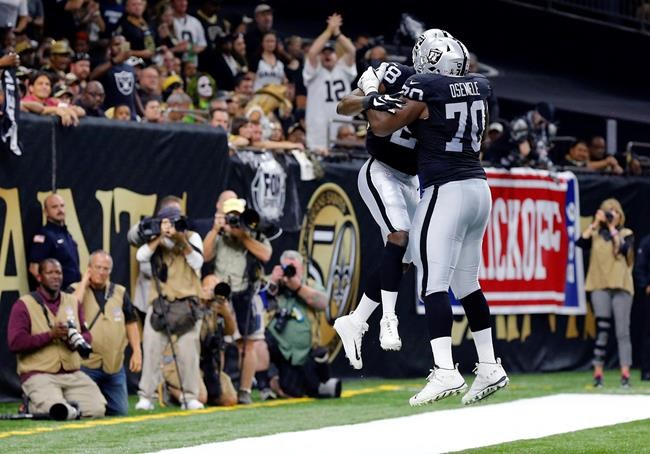 Oakland Raiders running back Latavius Murray celebrates his touchdown with offensive tackle Kelechi Osemele in the first half of an NFL football game in New Orleans Sunday Sept. 11 2016