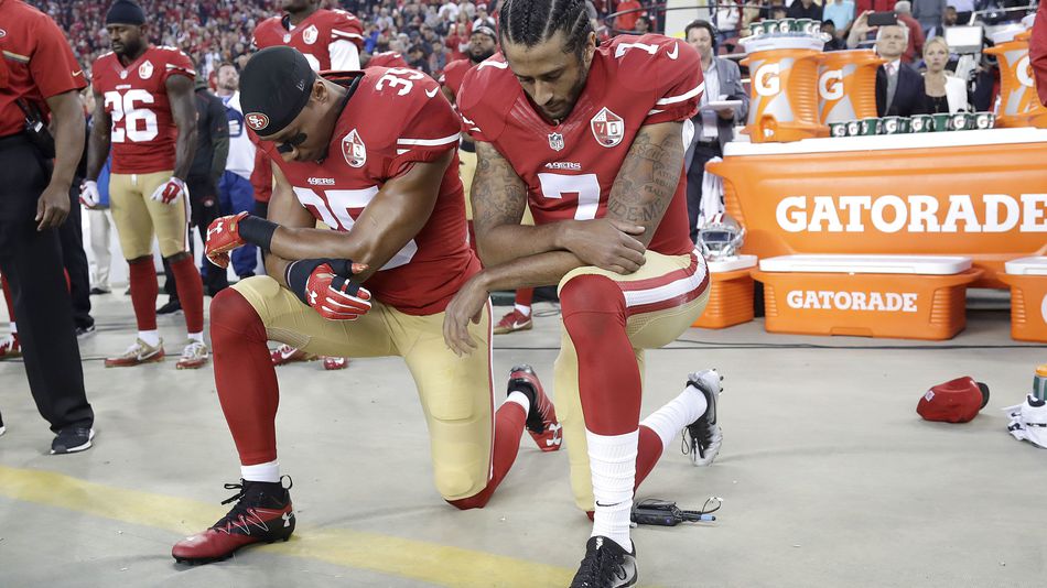 San Francisco 49ers Eric Reid and Colin Kaepernick kneeling during the national anthem