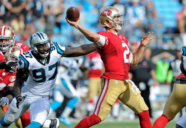 San Francisco 49ers&#39 Blaine Gabbert looks to pass under pressure from Carolina Panthers&#39 Mario Addison in the second half of an NFL football game in Charlotte N.C. Sunday Sept. 18 2016. The Panthers won 46-27