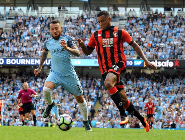 Manchester City's Nicolas Otamendi left and Bournemouth's Joshua King compete for the ball during the English Premier League soccer match between Manchester City and Bournemouth at the Etihad Stadium in Manchester England Saturday Sept. 17 2