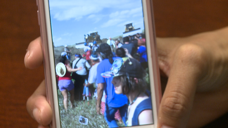 Sarah Ortegon shows video she shot at the Dakota Access Pipeline protest in North Dakota